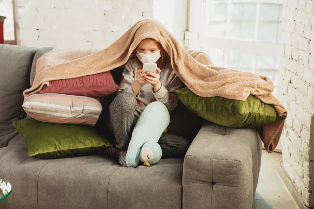 image of a girl on a couch with blankets | Benefits of Proper Ventilation | Ventit