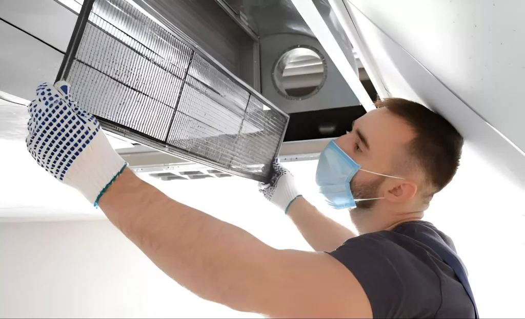 a professional changing an air filter | Common Ventilation Problems | Ventit